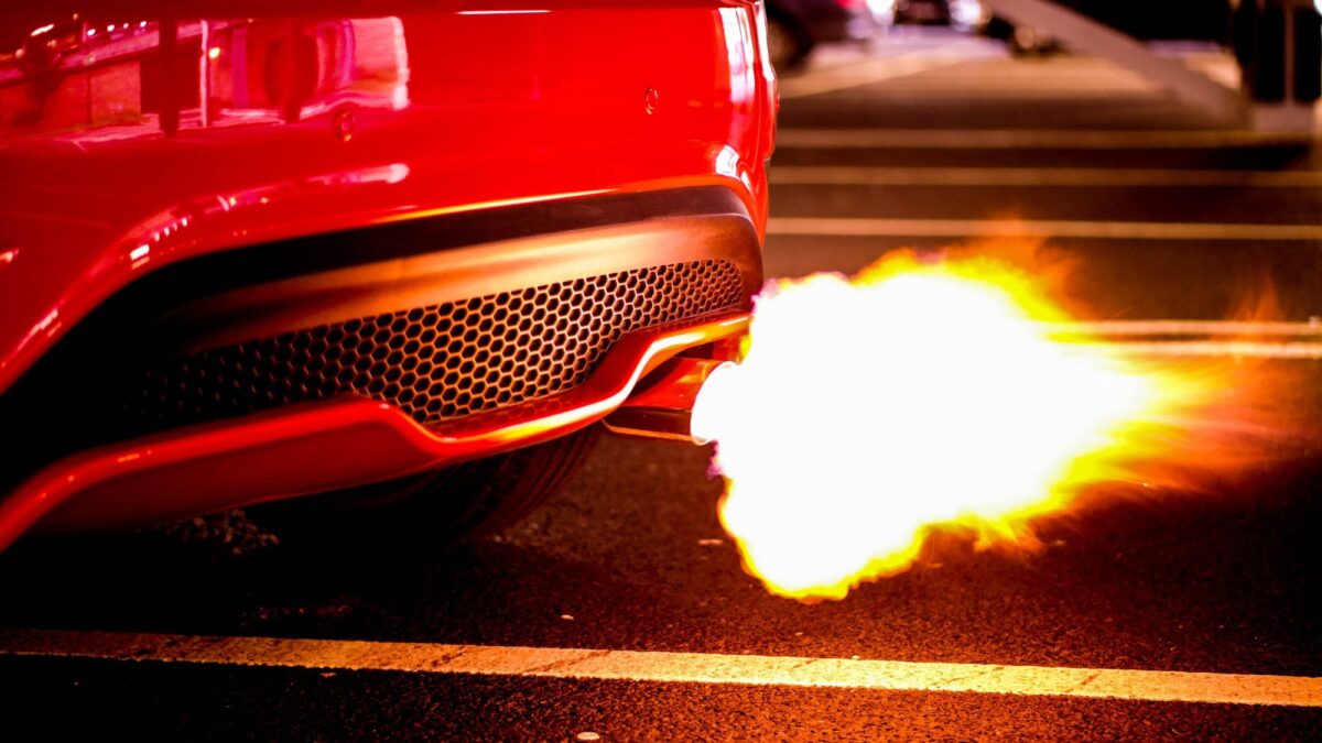 A red car with automobile exhaust system