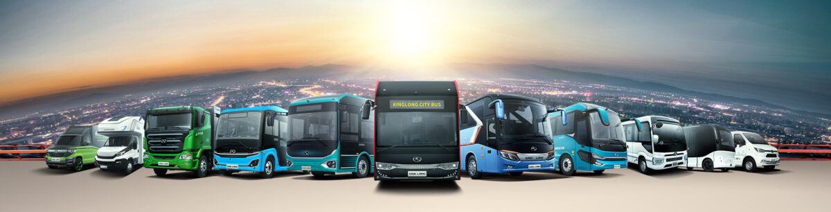 A fleet of luxury and standard buses from Bus Rental Dubai lined up in front of the iconic Dubai skyline at sunset.