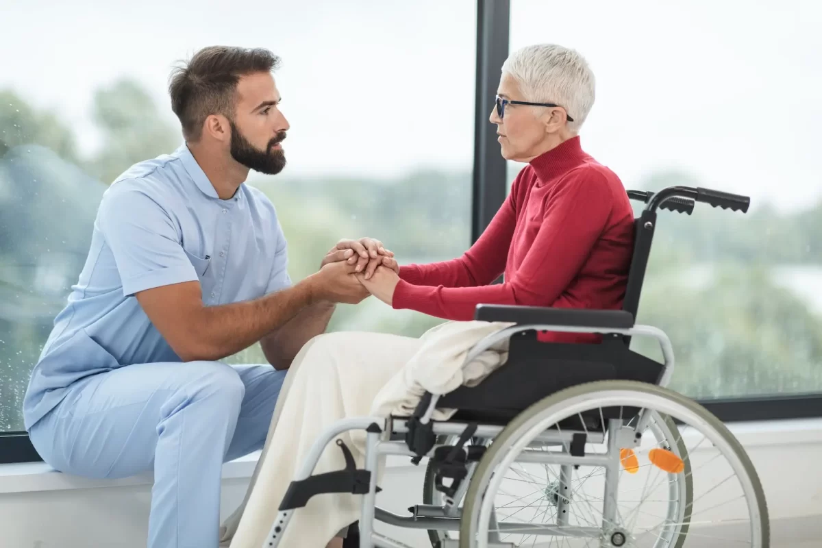 A caregiver offering support to an elderly person, representing local job opportunities in caregiving.