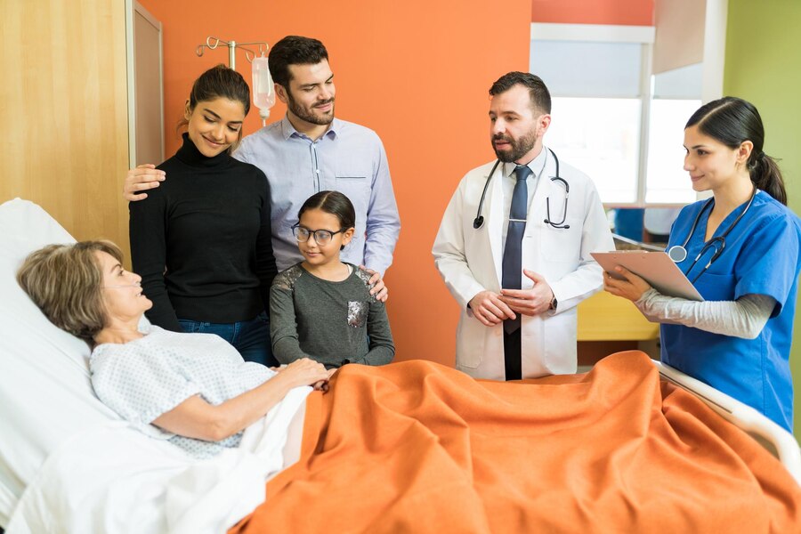 male-female-healthcare-workers-explaining-disease-senior-patient-with-family-hospital