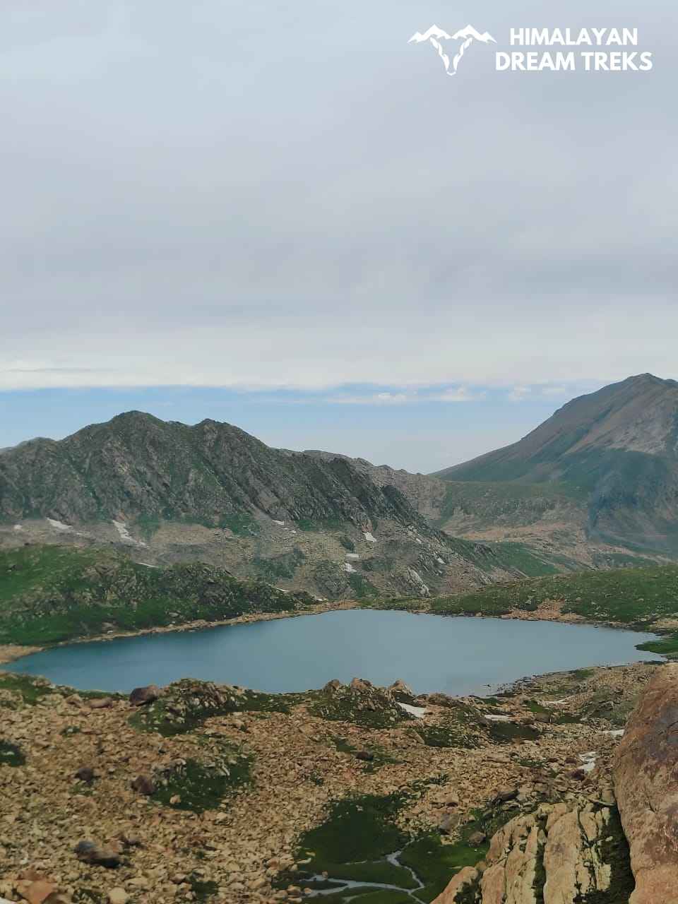 Lake with crystal-clear blue waters surrounded by mountains